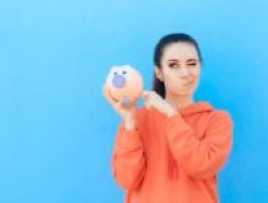 Frau mit Sparschwein in der Hand